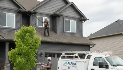 Technician performing gutter inspection on home exterior in Aurora, CO for Next Level Exteriors
